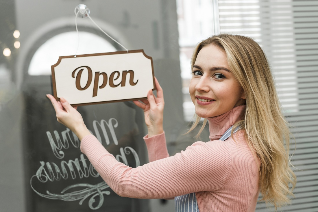 blonde young woman hanging open tag door entrance blonde young woman hanging open tag door entrance