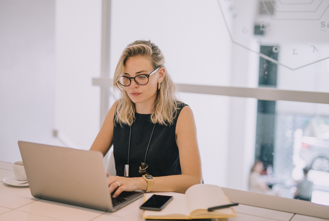young businesswoman using laptop at workplace young businesswoman using laptop at workplace
